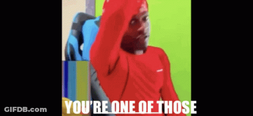 A Man In A Red Shirt Is Sitting In A Chair With The Words You 'Re One Of Those Above Him . GIF