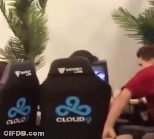 A Man In A Red Shirt Is Sitting In A Cloud 9 Chair . GIF