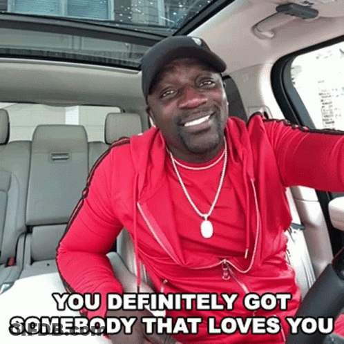 A Man In A Red Shirt Is Sitting In The Back Seat Of A Car With The Words You Definitely Got Somebody That Loves You Belo GIF