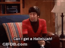 A Man In A Red Shirt Is Sitting On A Couch And Saying Can I Get A Hallelujah . GIF