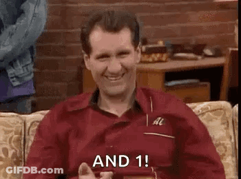 Man In Red Shirt Sitting On Couch Smiling With Phone GIF