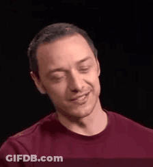 A Man In A Red Shirt Is Smiling And Making A Face . GIF