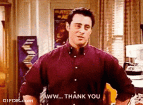 A Man In A Red Shirt Is Standing In A Kitchen And Saying Aww ... Thank You . GIF