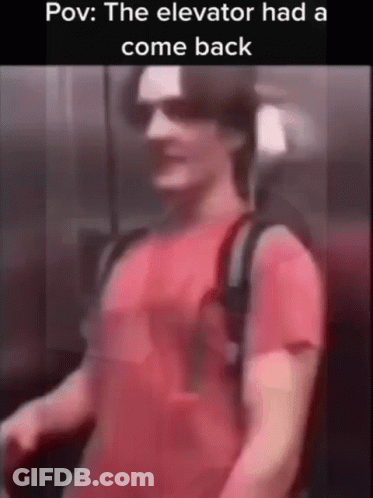 A Man In A Red Shirt Is Standing In An Elevator And The Elevator Had A Comeback . GIF
