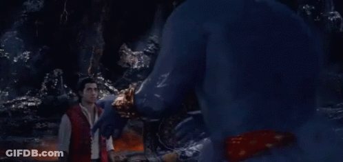A Man In A Red Shirt Is Standing In Front Of A Blue Monster GIF