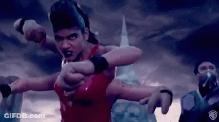 A Man In A Red Shirt Is Standing In Front Of A Group Of People And Pointing At Them . GIF