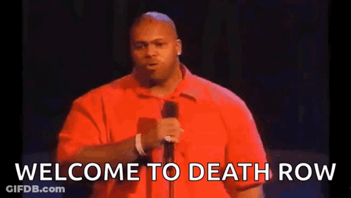 A Man In A Red Shirt Is Standing In Front Of A Microphone And Saying Welcome To Death Row . GIF