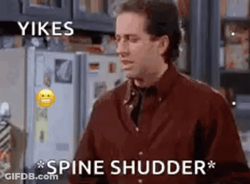 A Man In A Red Shirt Is Standing In Front Of A Refrigerator . GIF