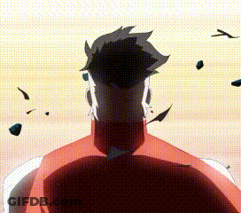 A Man In A Red Shirt Is Standing In Front Of A Sunset With Rocks Flying Around Him . GIF
