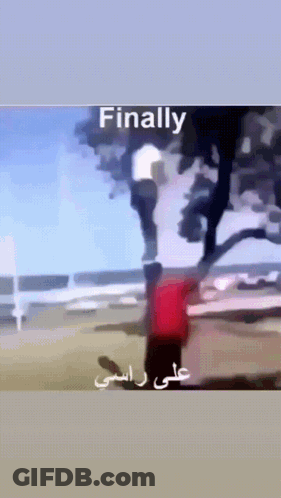 A Man In A Red Shirt Is Standing In Front Of A Tree And The Words Finally Are On The Bottom GIF