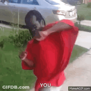 A Man In A Red Shirt Is Standing In Front Of A White Car And Says You . GIF