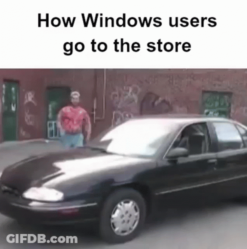 A Man In A Red Shirt Is Standing Next To A Black Car That Says How Windows Users Go To The Store GIF