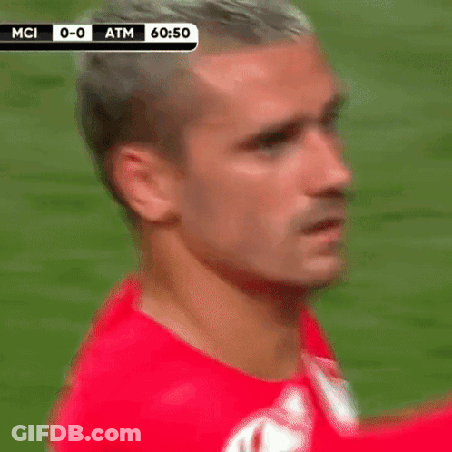 A Man In A Red Shirt Is Standing On A Soccer Field With A Score Of 0-0 Atm GIF