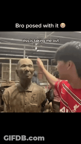 A Man In A Red Shirt Is Touching A Statue With The Caption " Bro Posed With It " GIF