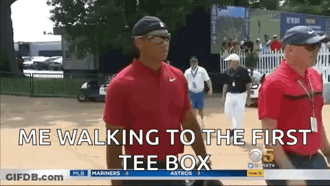 A Man In A Red Shirt Is Walking To The First Tee Box .. GIF