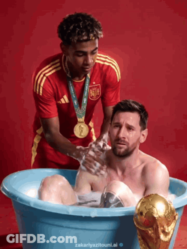 A Man In A Red Shirt Is Washing Another Man In A Blue Tub GIF