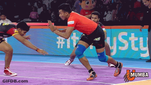 A Man In A Red Shirt Is Wrestling Another Man On A Purple Court GIF