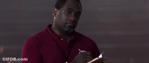 A Man In A Red Shirt Is Writing In A Notebook . GIF