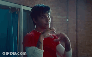 A Man In A Red Shirt Making A Heart With His Hands GIF