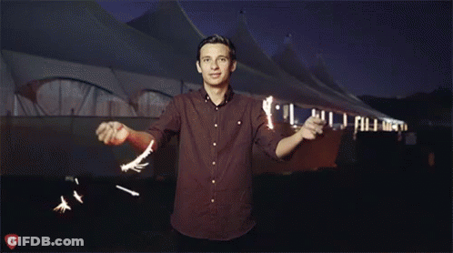 A Man In A Red Shirt Stands In Front Of A Tent With A Fl Logo On The Bottom GIF