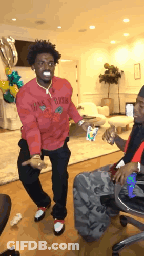 A Man In A Red Shirt That Says Guns N Roses GIF