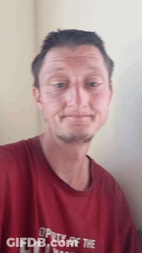 A Man In A Red Shirt That Says Property Of The GIF