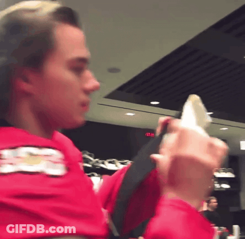 A Man In A Red Shirt With A Chevrolet Logo On His Arm GIF