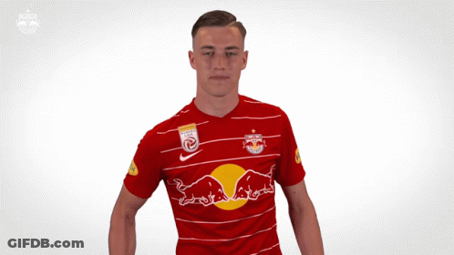 A Man In A Red Shirt With A Red Bull On It GIF