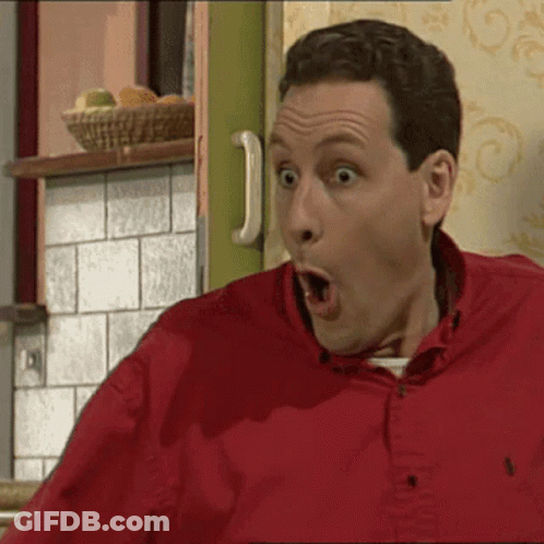 A Man In A Red Shirt With His Mouth Wide Open GIF