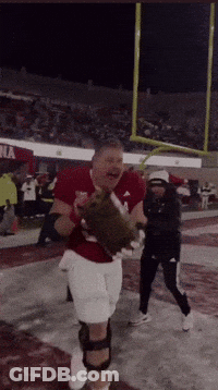 A Man In A Red Shirt With The Number 1 On It Is Holding A Glove GIF