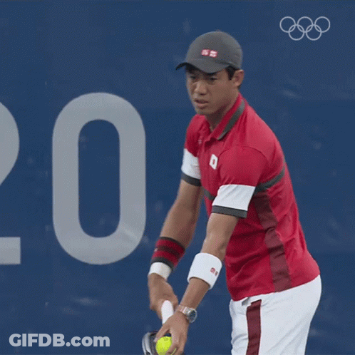 A Man In A Red Shirt With The Number 8 On It Is Playing Tennis GIF