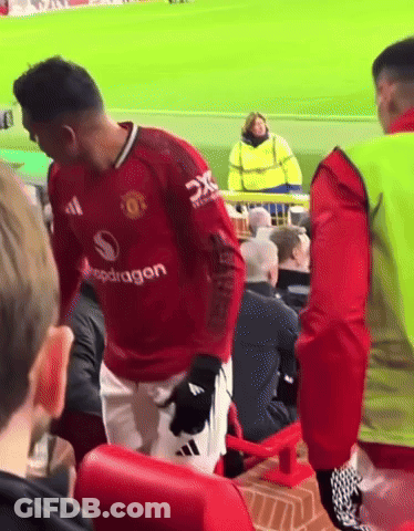 A Man In A Red Shirt With The Word Dragon On The Sleeve GIF