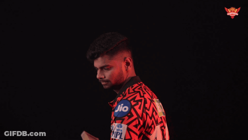 A Man In A Red Shirt With The Word Her On It Is Holding A Bat GIF