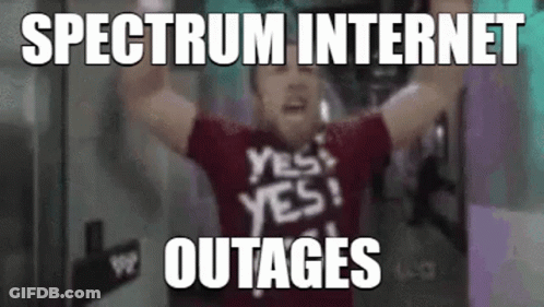A Man In A Red Shirt With The Words `` Spectrum Internet Outages '' Written On It Is Holding His Arms Up In The Air . GIF