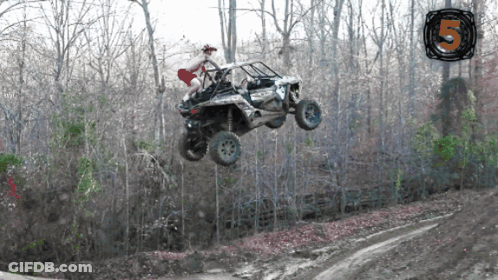 Man In Red Shorts Riding ATV In Air GIF