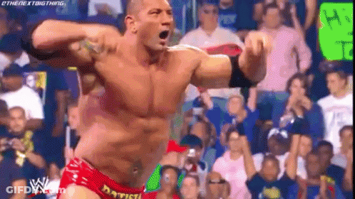A Man In A Red Shorts Is Standing In Front Of A Crowd . GIF