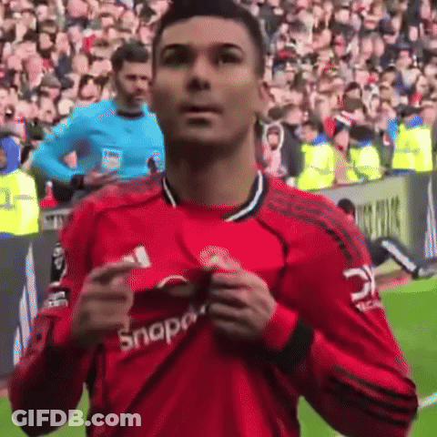 A Man In A Red Snap On Shirt Stands On A Field GIF