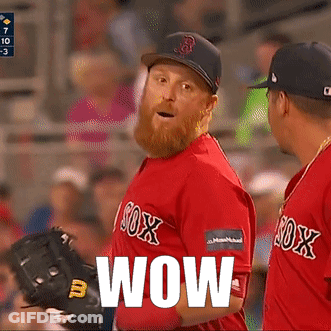 A Man In A Red Sox Jersey Says Wow In Front Of Another Man GIF