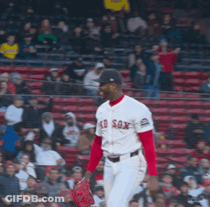 A Man In A Red Sox Jersey Stands In Front Of A Crowd Of People GIF