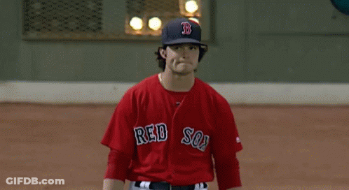 A Man In A Red Sox Jersey Stands On The Field GIF
