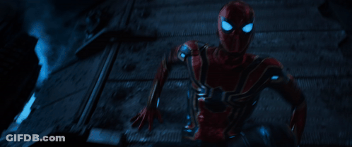 A Man In A Red Spiderman Costume Is Running In The Dark GIF