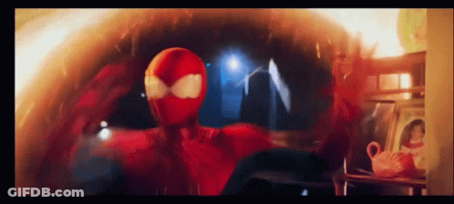 A Man In A Red Spiderman Costume Is Standing In A Room GIF