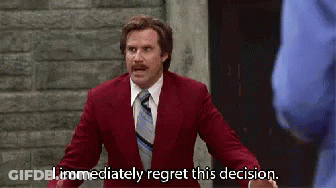 A Man In A Red Suit And Tie Is Making A Funny Face And Saying `` I Immediately Regret This Decision '' . GIF