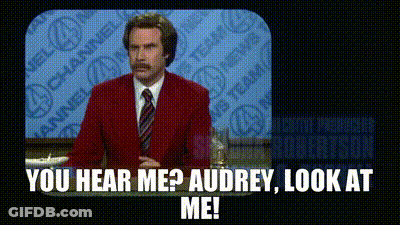 A Man In A Red Suit And Tie Is Standing In Front Of A Television And Says You Hear Me ? Audrey Look At Me . GIF