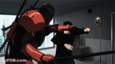 A Man In A Red Suit Is Fighting Another Man In A Black Suit . GIF