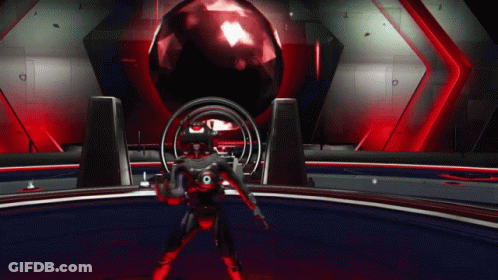 A Man In A Red Suit Is Standing In Front Of A Red Ball GIF