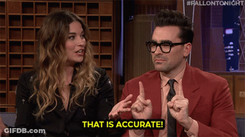 A Man In A Red Suit Says That Is Accurate While Talking To A Woman GIF