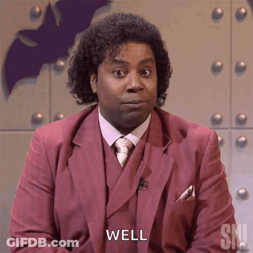 A Man In A Red Suit Says Well In Front Of A Bat GIF
