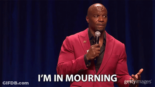 A Man In A Red Suit Stands In Front Of A Microphone And Says I 'M In Mourning GIF