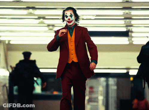 A Man In A Red Suit With A Clown Face GIF